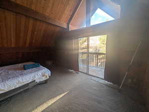 Carpeted bedroom featuring high vaulted ceiling, beam ceiling, wood ceiling, and access to exterior