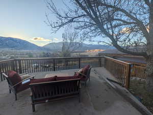 Deck with a mountain view and outdoor lounge area