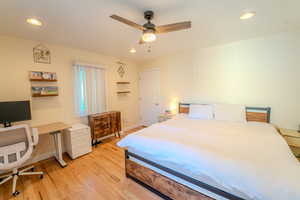 Bedroom with light hardwood / wood-style floors and ceiling fan