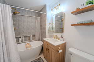 Bathroom with vanity, toilet, and a shower with shower curtain