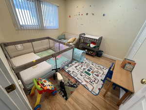 Bedroom with hardwood / wood-style flooring