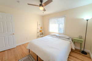 Bedroom featuring ceiling fan and light wood-type flooring