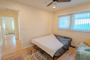 Bedroom featuring light hardwood / wood-style flooring and ceiling fan