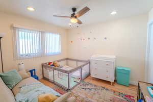 Bedroom with light hardwood / wood-style flooring and ceiling fan