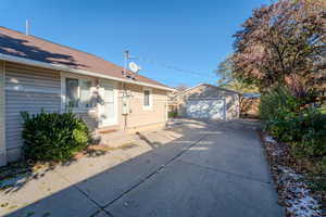 Exterior space with a garage and an outbuilding