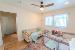 Living room featuring light hardwood / wood-style floors and ceiling fan