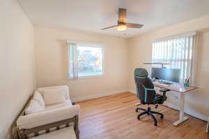 Office with ceiling fan and light hardwood / wood-style floors