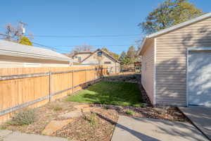 View of yard featuring a garage and an outdoor structure