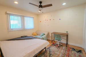 Bedroom with hardwood / wood-style flooring and ceiling fan