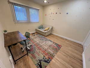 Bedroom with hardwood / wood-style floors