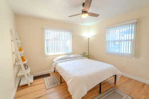 Bedroom with ceiling fan and light hardwood / wood-style floors