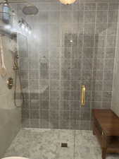 Bathroom with tile patterned floors and an enclosed shower