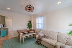 Dining area featuring hardwood / wood-style flooring and crown molding