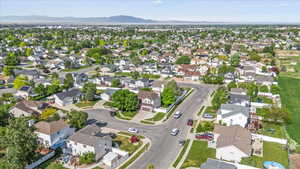 Aerial view of property's location with a mountain backdrop and nearby suburban area