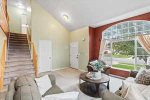 Living room with high vaulted ceiling