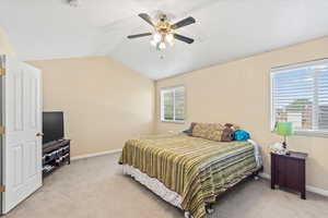 Master bedroom with vaulted ceiling, and ceiling fan