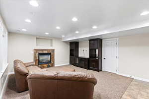 Carpeted living room with a fireplace