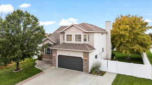 View of property with a front lawn and a garage