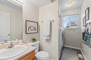 Bathroom featuring vanity, and washer and dryer