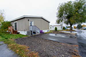 View of home's exterior with central AC