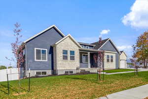 View of front of home with a front lawn and a garage