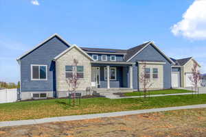 View of front of home with a front lawn and covered porch