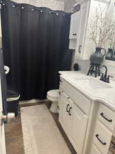 Bathroom featuring vanity, tile patterned floors, and toilet