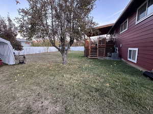 View of yard featuring a wooden deck and central AC