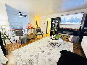 Living room featuring hardwood / wood-style floors and ceiling fan