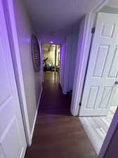 Corridor with dark hardwood / wood-style floors