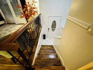 Stairs featuring tile patterned floors