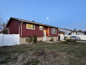 Split foyer home featuring a garage