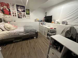 Bedroom with wood-type flooring