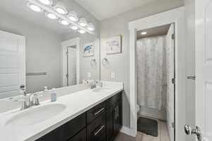 Full bathroom featuring toilet, vanity, shower / bath combination with curtain, and tile patterned floors