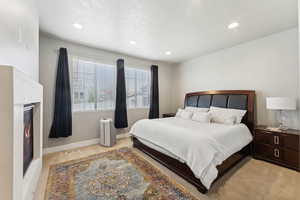 Carpeted bedroom featuring a textured ceiling