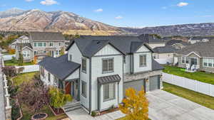 View of front of home with a garage, a front yard, and a mountain view