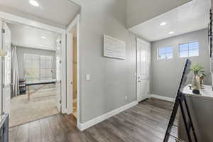 Entryway with hardwood / wood-style floors, plenty of natural light, and a textured ceiling