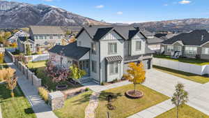 View of front of property with a front lawn, a mountain view, and a garage