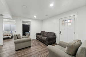 Living room featuring wood-type flooring and a healthy amount of sunlight