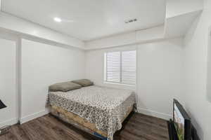 Bedroom with dark hardwood / wood-style floors