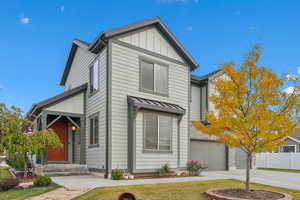 View of front of home with a front lawn and a garage