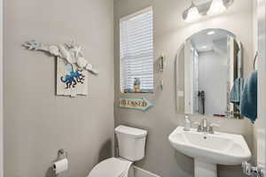 Bathroom featuring sink and toilet