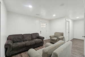 Separate entrance to the basement. Living room with hardwood / wood-style floors