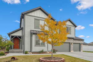 View of front of home with a garage and a front yard