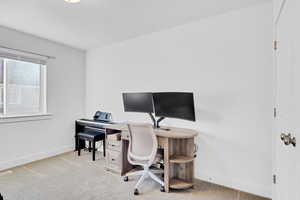 Office space featuring light colored carpet