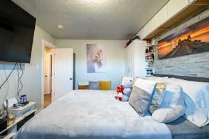 Bedroom featuring a textured ceiling