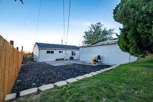 Back of property featuring central AC unit, a lawn, and Garden