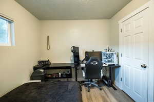 Office featuring wood-type flooring and a textured ceiling