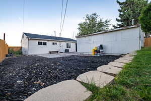 Back of property featuring garden & woodchips