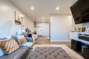 Living room with light hardwood / wood-style Vinyl flooring